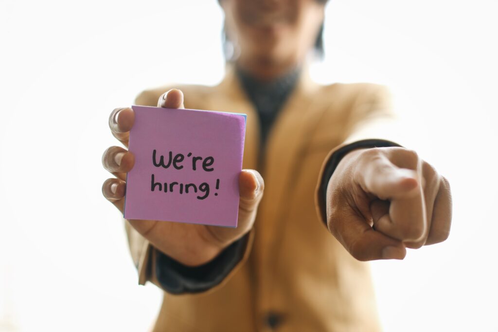 Businessman Pointing To You And Showing We're Hiring